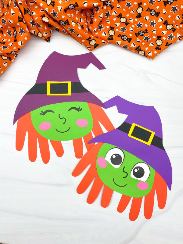 Handprint craft of two witches with colorful hats on a white background.