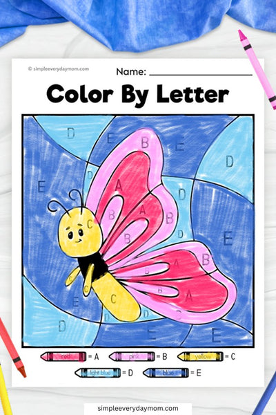 A "Color by Letter" worksheet of a cheerful butterfly with pink and red wings, a yellow body, and a blue sky background, using letter-coded coloring.