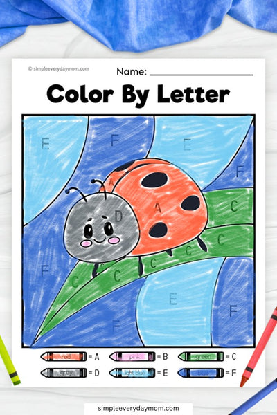 A "Color by Letter" worksheet of a cute ladybug with a red shell and black spots, resting on a green leaf against a blue sky, colored by matching letters to a key.