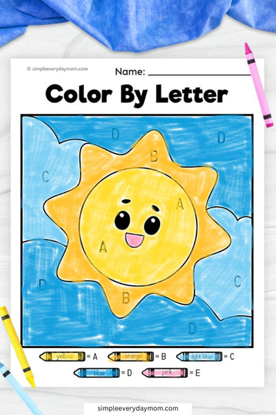 A "Color by Letter" worksheet of a happy, cartoon-style sun with a yellow and orange face, set against a blue sky, with letter-labeled sections matching a color key.