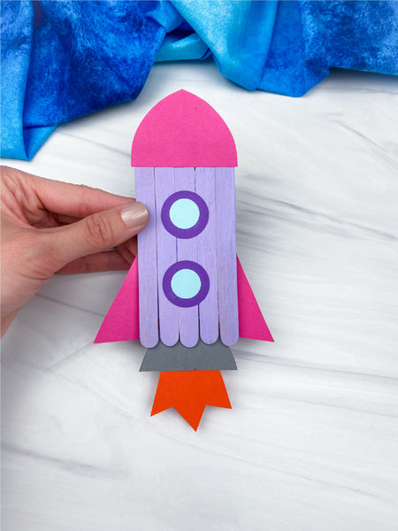 hand holding rocket popsicle stick craft