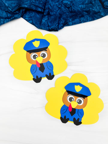 Two cartoon police officer turkeys on white background with blue fabric