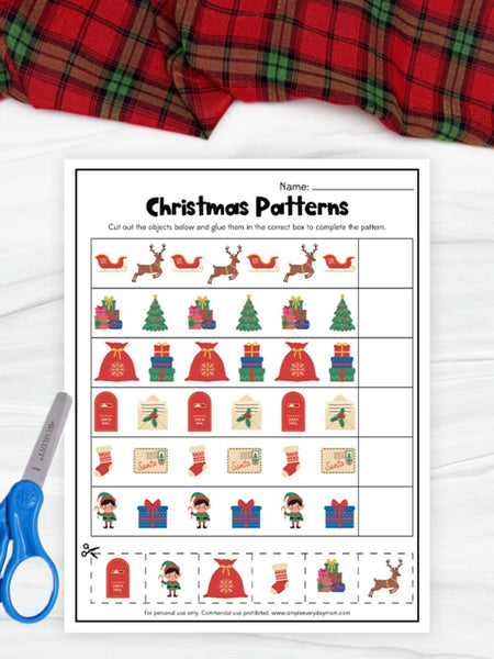 Christmas-themed pattern worksheet with cut-out items and a plaid fabric background.
