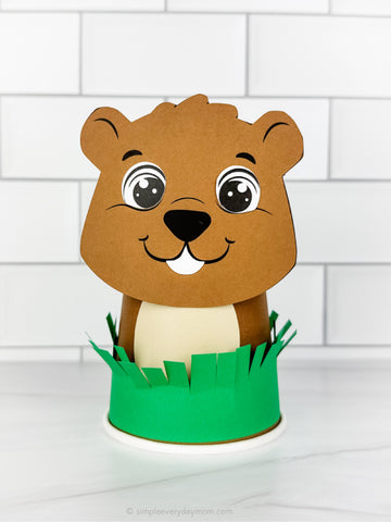 Groundhog paper cup craft on marble counter with white subway title background