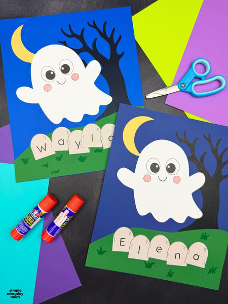Two Halloween ghost name crafts featuring smiling white ghosts, yellow crescent moons, black trees, and green grassy hills. Personalized tombstones spell out the names Waylon and Elena, with colorful construction paper, scissors, and glue sticks surrounding the crafts.