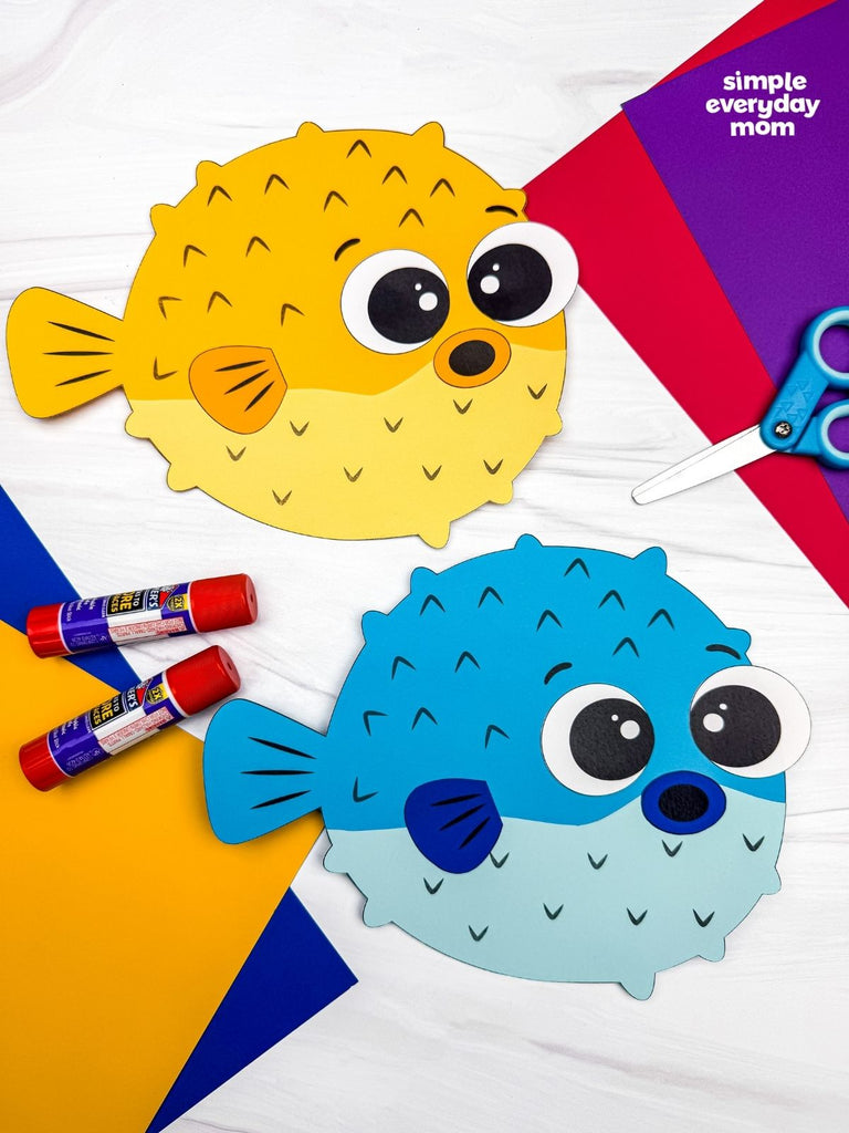 Colorful paper fish craft with markers and scissors on a colorful background