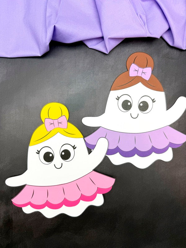 two ballerina ghost disguise crafts on black background with purple fabric on top