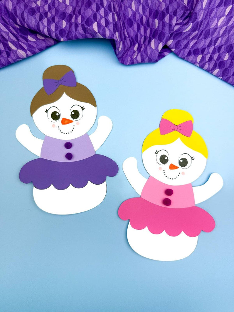 Two snowmen disguised as ballerinas on a blue background with purple fabric on top
