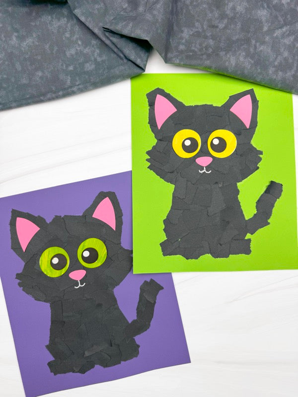 Two black cat wall torn paper crafts with pink ears and large yellow eyes, displayed on purple and green backing papers with a gray fabric runner at the top.