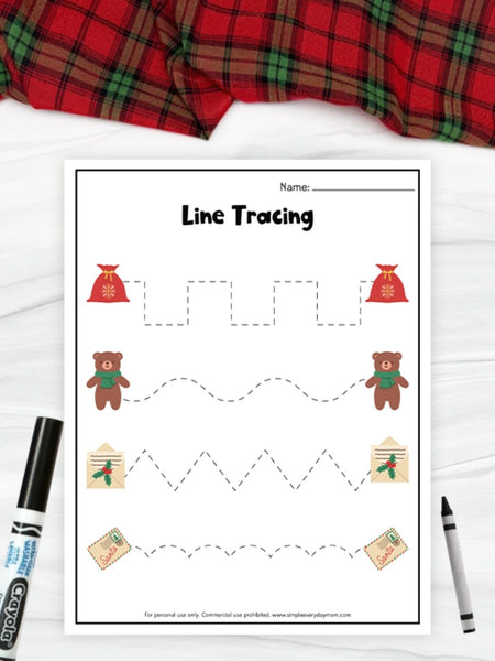 Line tracing worksheet with teddy bears and a red plaid fabric in the background