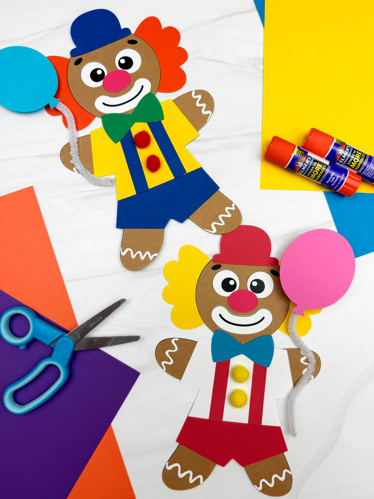 two clown gingerbread man disguise crafts on white background with scissors, glue, and paper. 