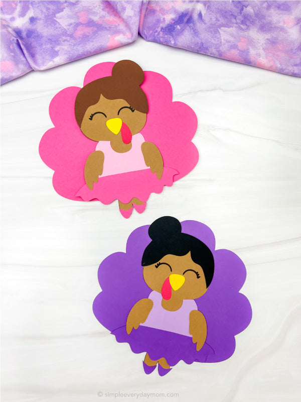 Two paper cutouts of a ballerina turkey disguise on a white background