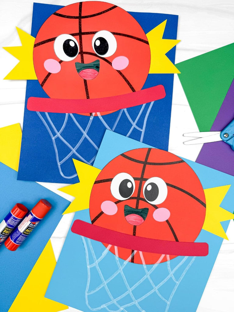 Two basketball crafts on a white background with colored paper, scissors, and glue sticks 