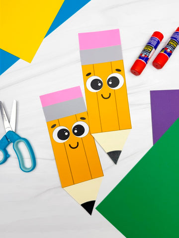 Children's craft project with paper pencils and craft supplies on a colorful background