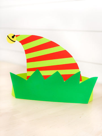 Colorful paper elf hat with red and green stripes on a white background