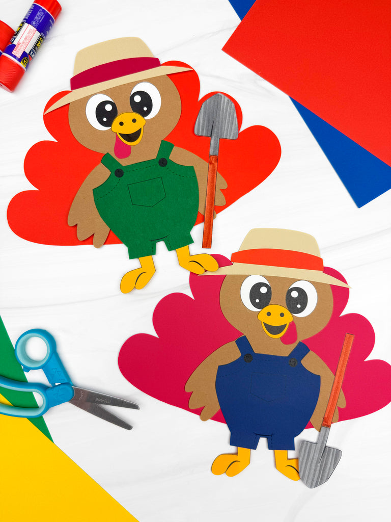 Two paper cutouts of turkeys disguised as a farmer with a pair of scissors and glue stick on a colorful background.