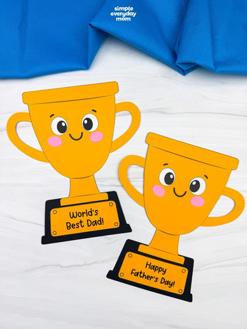 Two cartoon trophy crafts with 'World's Best Dad!' and 'Happy Father's Day!' signs on a white background.