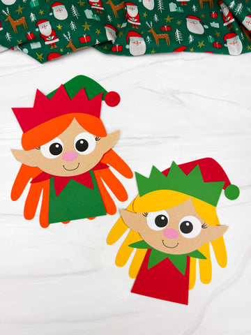 2 handprint girl elf crafts on marble background with fabric on top
