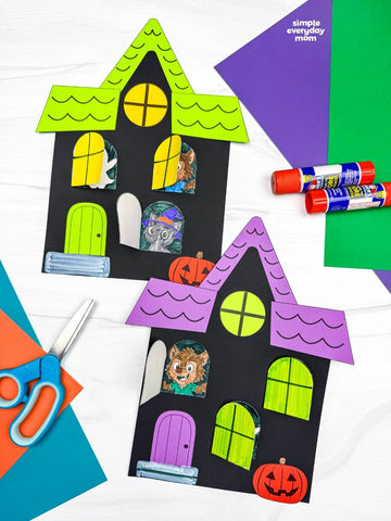 Two haunted house crafts with peekaboo windows on white background with colored paper, scissors, and glue. 