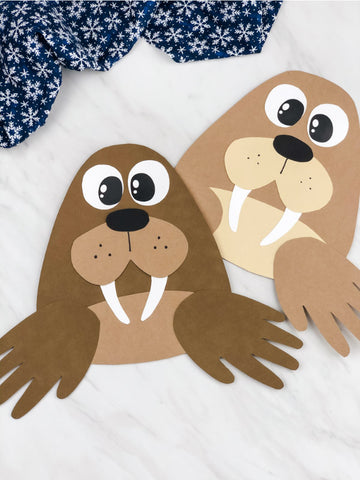 Two hand-shaped walrus crafts on a white background with a blue and white patterned fabric.