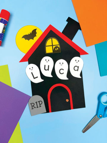 Halloween haunted house craft with the name "Luca" on a colorful background.