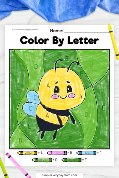 A "Color by Letter" worksheet of a cute bumblebee with yellow and black stripes, blue wings, and a green background, colored according to letter-coded sections.