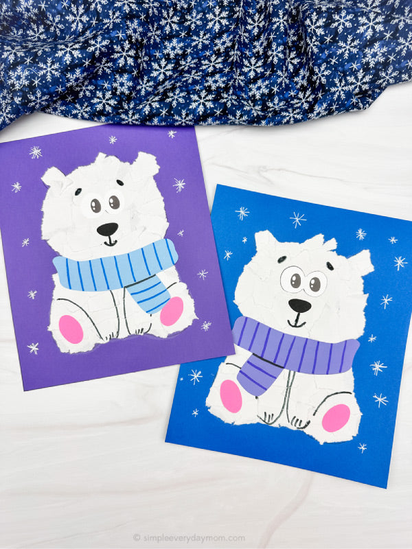 Two torn paper polar bear crafts on white background with snowflake fabric