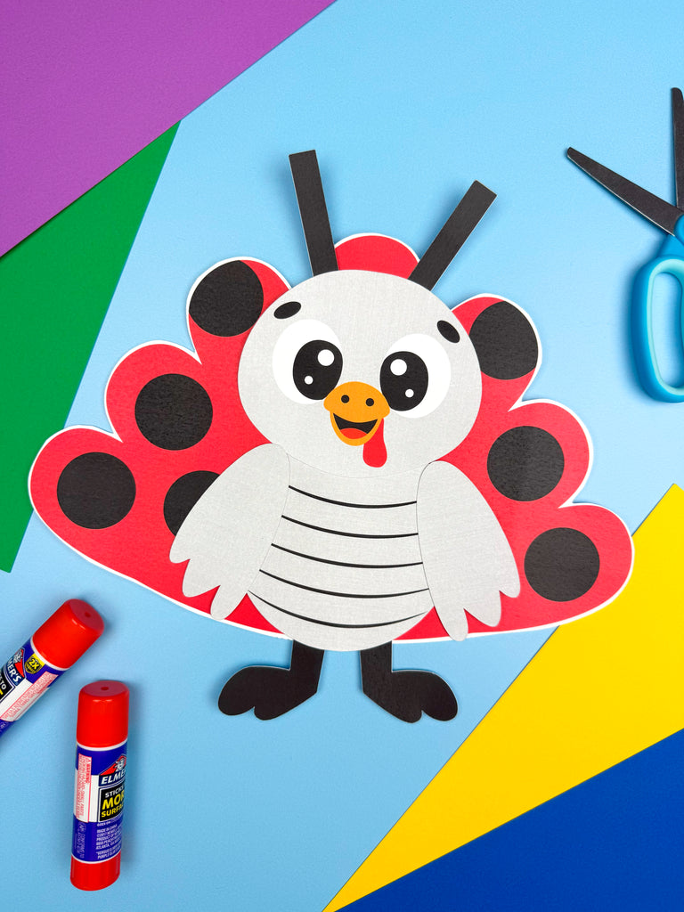 Children's craft project of a turkey disguised as a ladybug with construction paper and glue on a colorful background