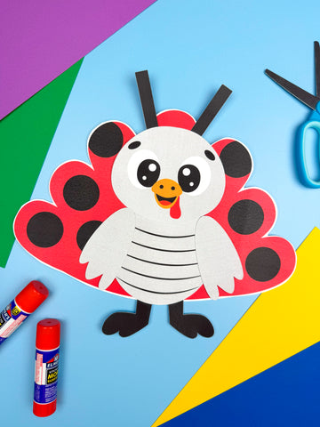 Children's craft project of a turkey disguised as a ladybug with construction paper and glue on a colorful background