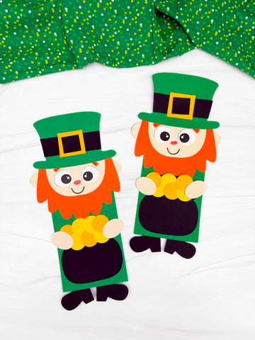 Two paper leprechaun crafts with pots of gold on a white background.