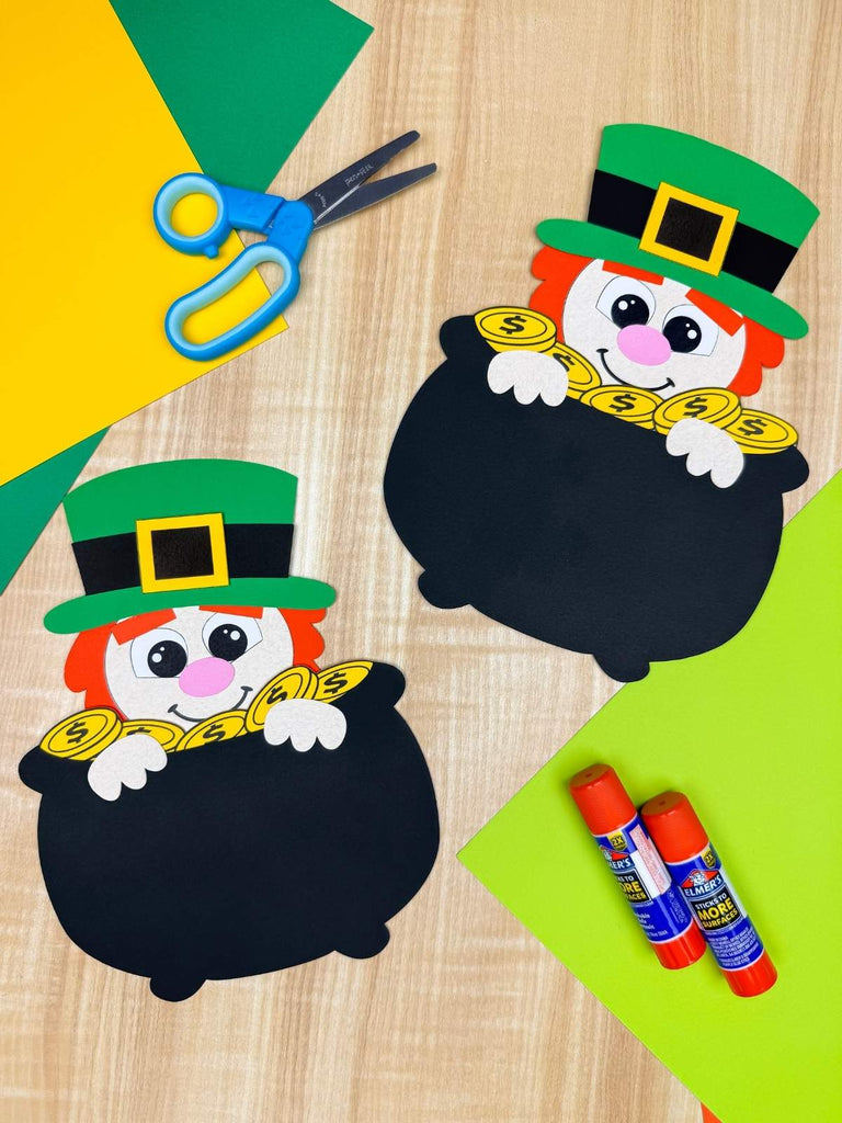 leprechaun in a pot of gold crafts on wood background with crafts supplies
