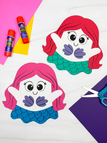 Two mermaid-themed ghost disguise crafts with glue sticks and scissors on a colorful background