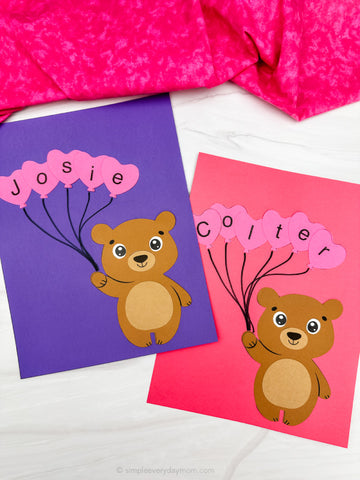 Two Valentine bear name crafts for kids on a white background with pink fabric