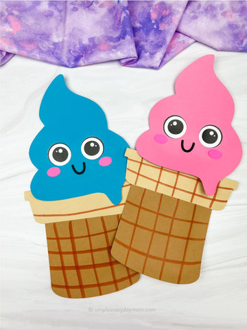 Two ice cream paper bag puppet crafts on a white background with purple fabric on top 