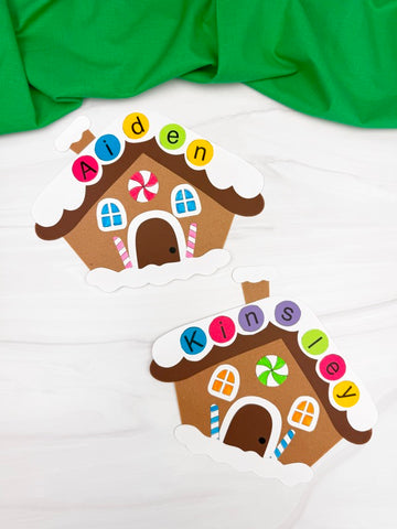 Two gingerbread house-shaped name crafts with colorful letters on a white background.