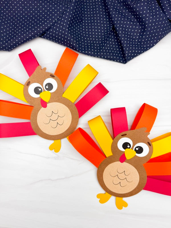Two paper turkeys with colorful feathers on a white background