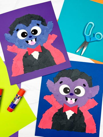 Children's craft project of a cartoon vampire on colored paper with scissors and glue.