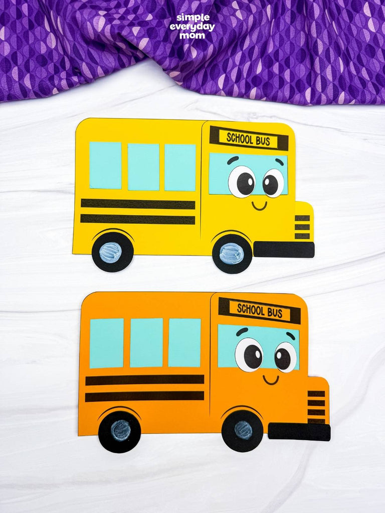 2 bus shape crafts on white background with purple fabric on top