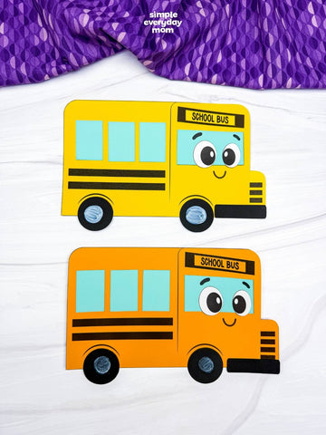 2 bus shape crafts on white background with purple fabric on top