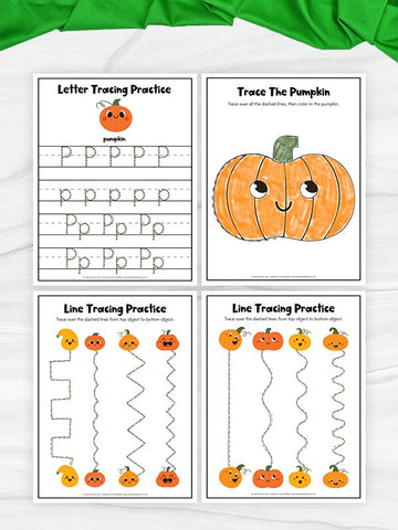 Four printable pumpkin-themed tracing worksheets arranged in a 2x2 grid on a white marble surface with a green fabric bow at the top. The worksheets include letter tracing practice, a pumpkin tracing activity, and line tracing practice with pumpkins.