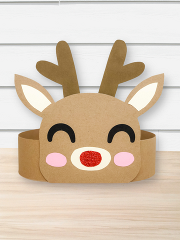 Reindeer face headband craft on a wooden surface with a white wooden panel background