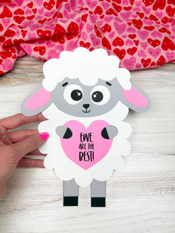 hand holding sheep Valentine craft with heart fabric