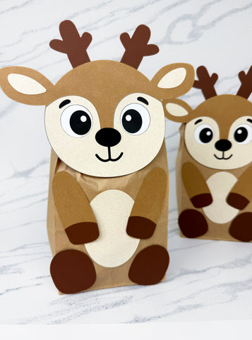 Two paper bag reindeer on a white background
