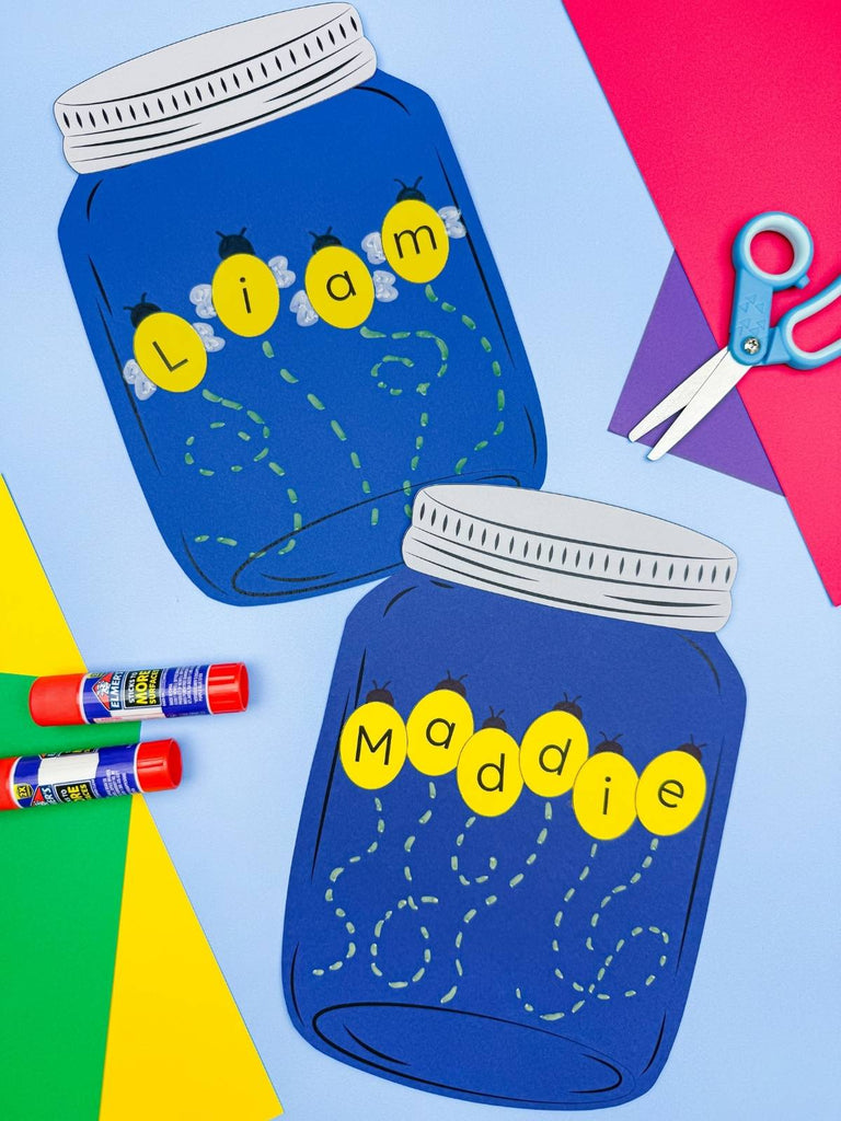 Two firefly name crafts on blue background with scissors, glue sticks and colored paper.