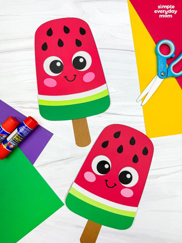 Colorful paper craft of a watermelon popsicle with smiling face on a white background.