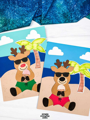 Two reindeer beach crafts for kids on white background with blue fabric on top