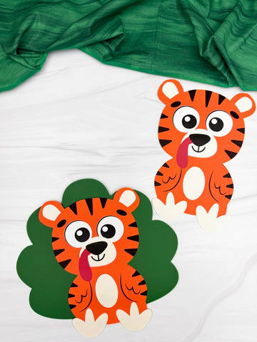 Two turkeys disguised as tigers on a white background with green fabric above.