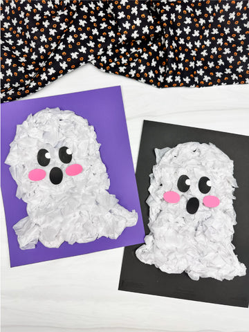 Two tissue paper ghost crafts on purple and black paper with a Halloween-themed fabric background.