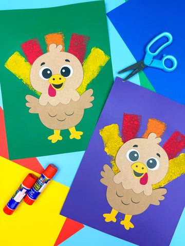 Two colorful paper turkeys with construction paper, glue, and scissors on a blue background.