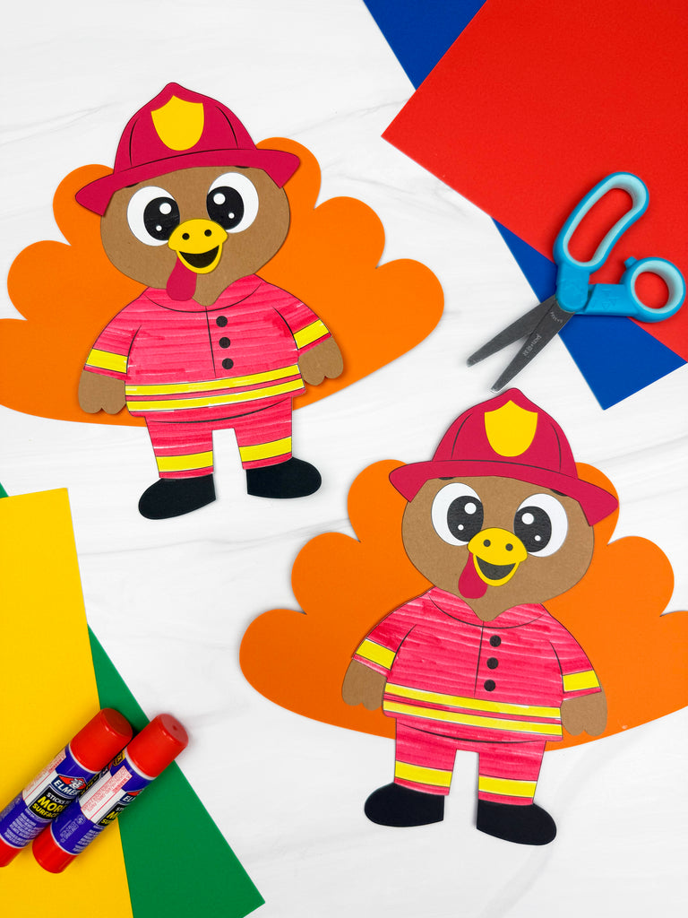 Two paper cutouts of turkeys dressed as firefighters with scissors and glue sticks on a colorful background.